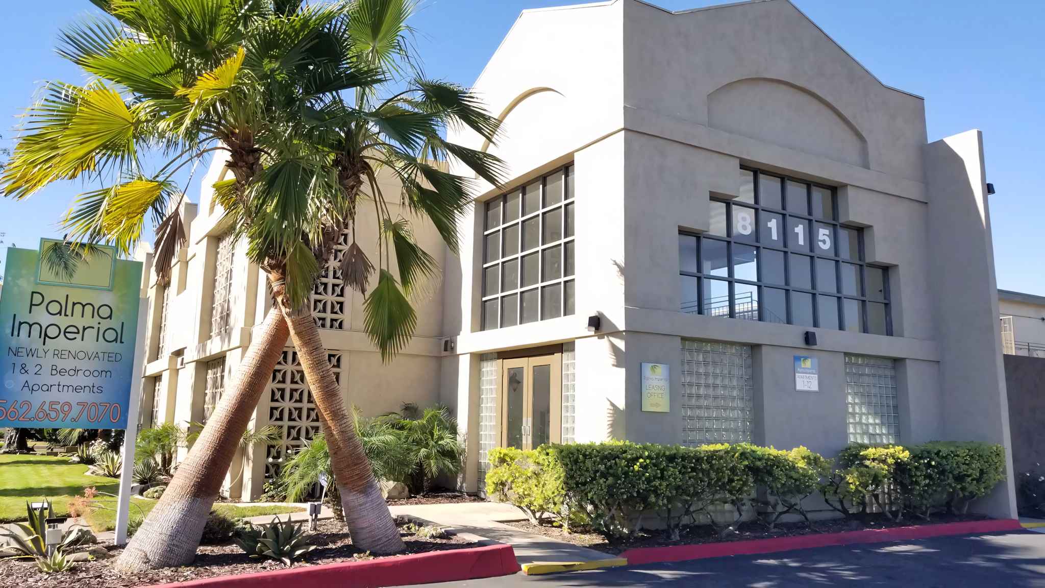 Palma Imperial leasing office entrance and palm tree landscaping