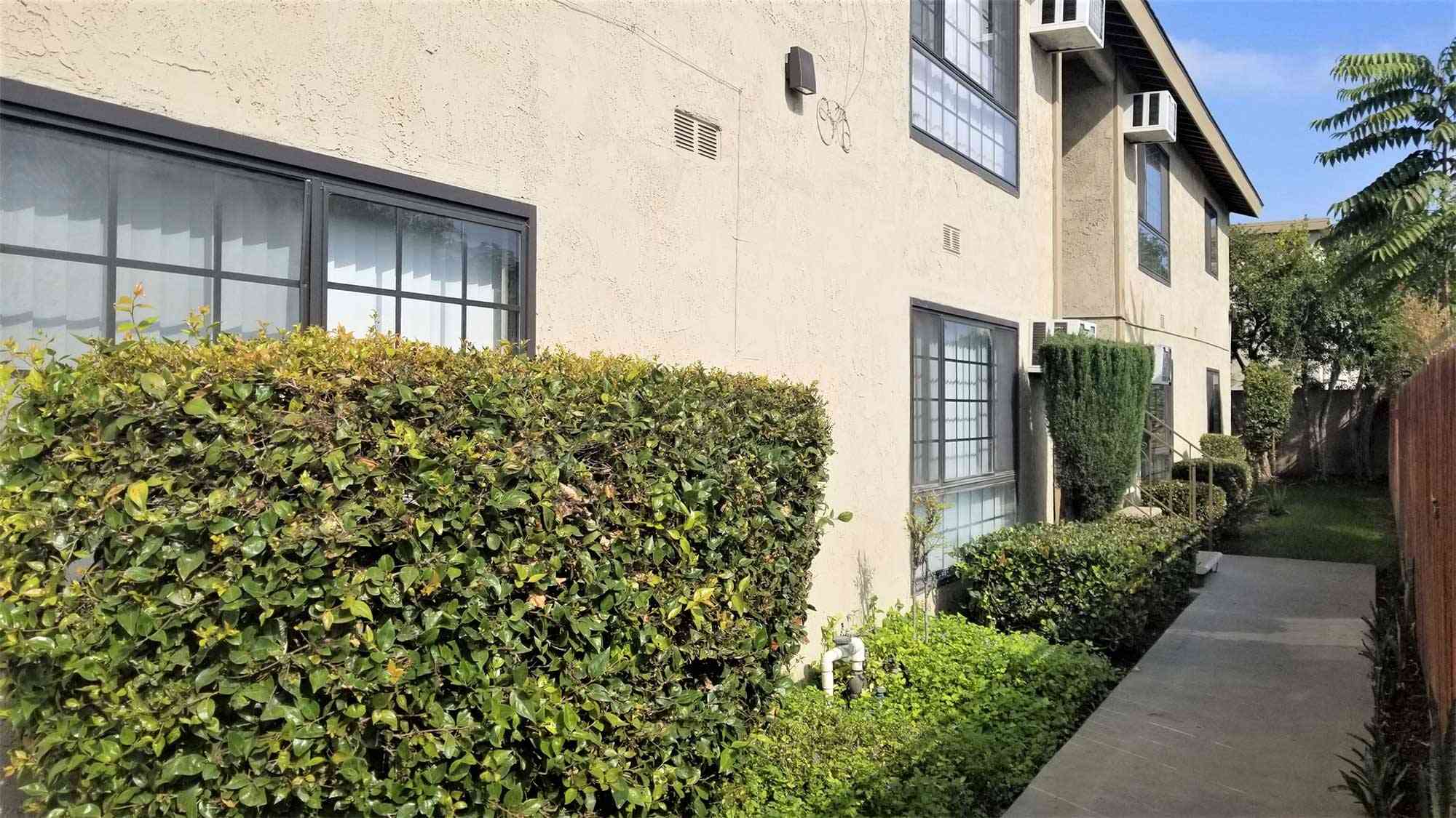 exterior walkway with manicured landscaping