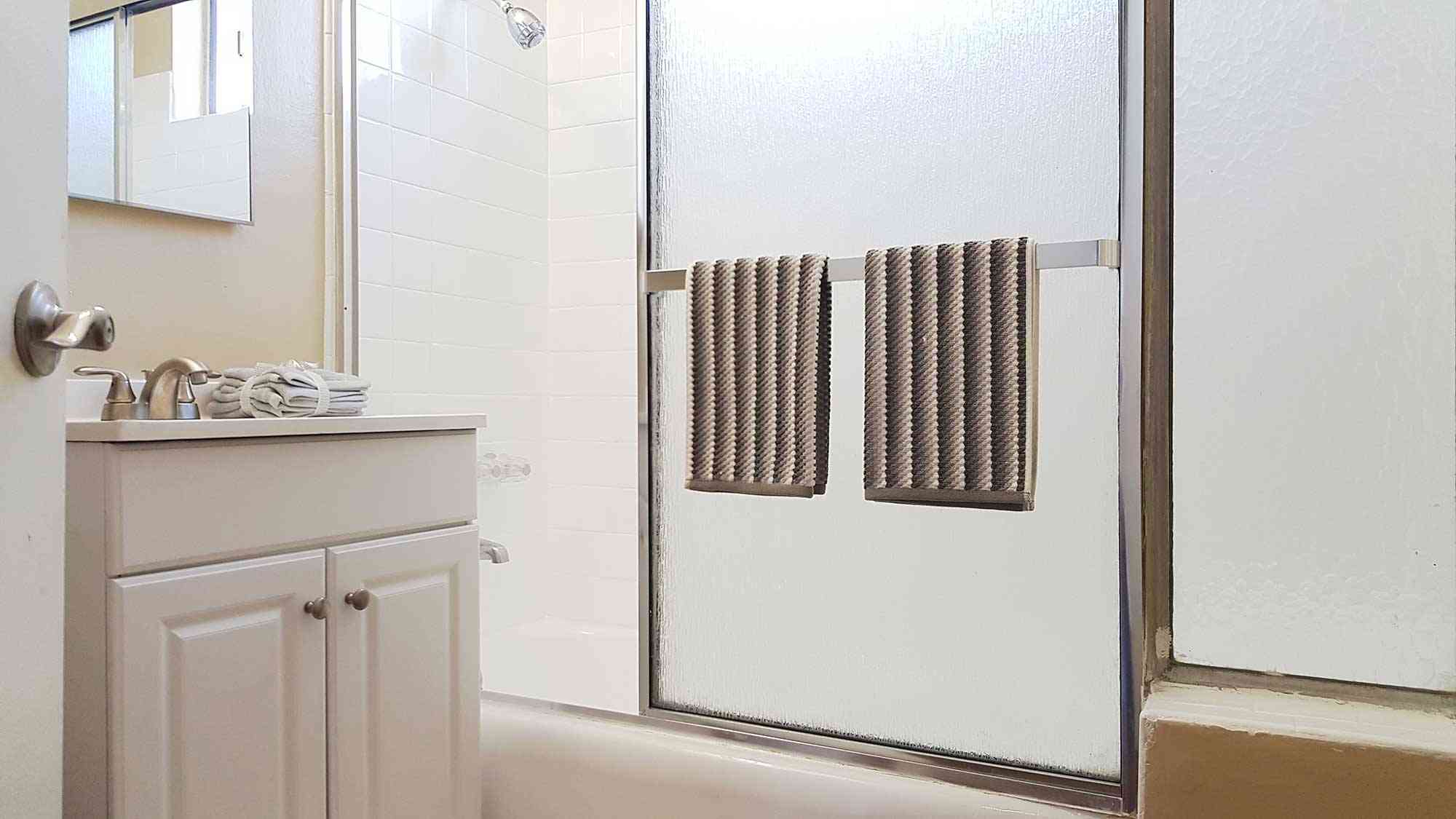 renovated bathroom with glass shower enclosure