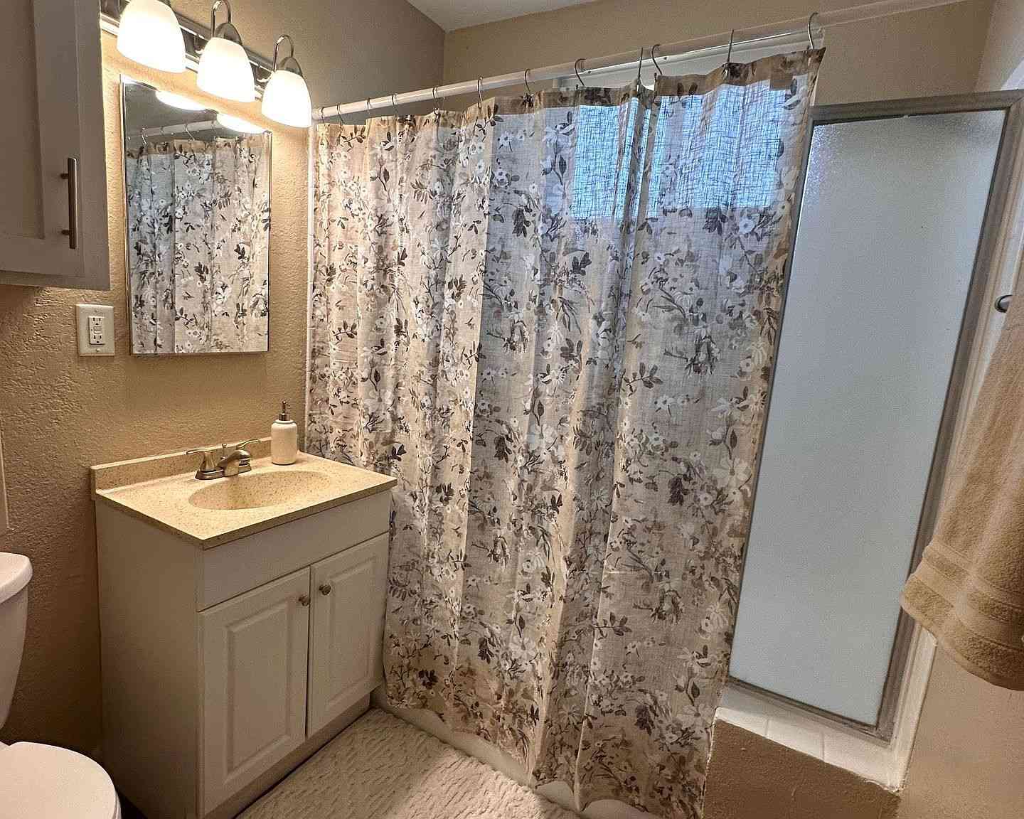 updated guest bathroom with modern lighting